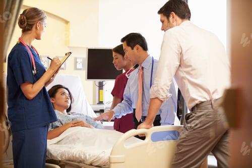 Preview: Medical Team Meeting Around Female Patient In Hospital Room