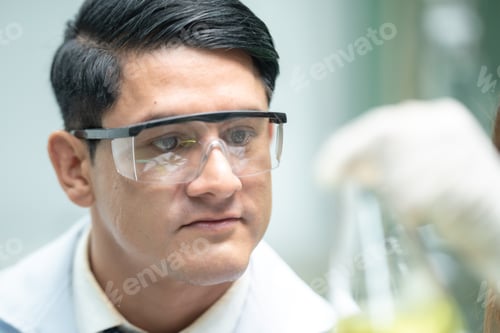 Preview: Pharmaceutical factory woman worker in protective clothing operating production line