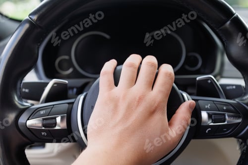 Preview: Hand Pressing Horn on Car Steering Wheel