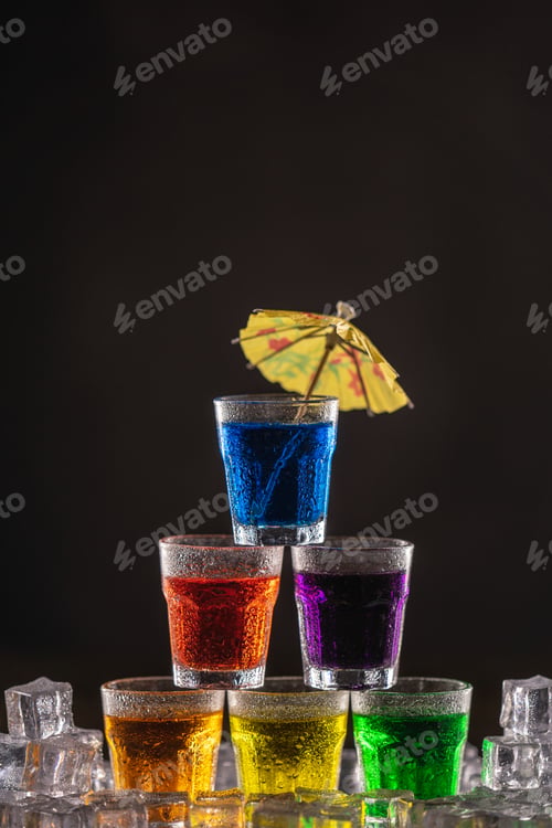 Preview: Pyramid of shots with colorful alcohol, decorated with umbrellas for cocktails
