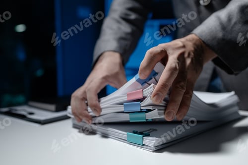 Preview: An employee held a large pile of documents in his hand, Large piles of work documents on desks are b