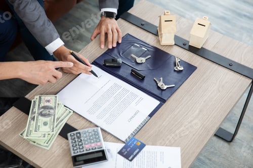 Preview: A business transaction scene with hands signing a contract