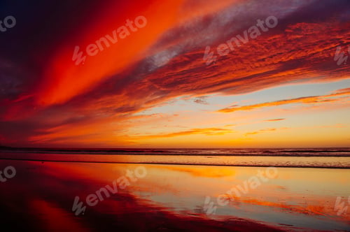 Preview: Deserted beach under dramatic orange sky at sunset, San Diego, California, USA
