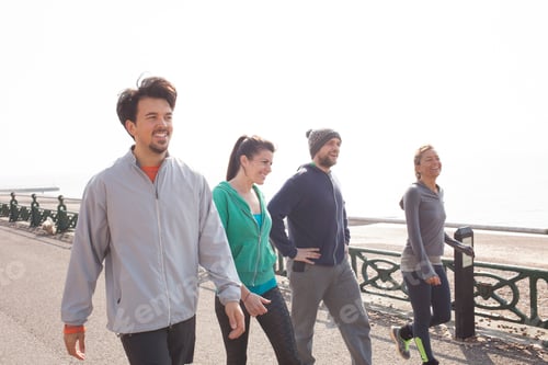 Preview: Male and female runners preparing to run at Brighton beach