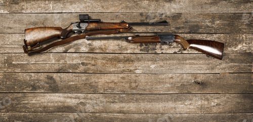 Preview: Hunting weapon on dark wooden backgorund, top view