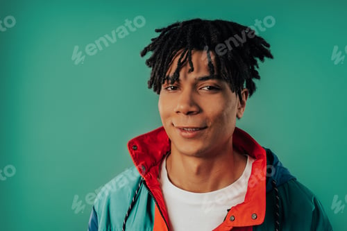 Preview: Portrait of stylish african man in colorful outfit. Handsome guy on green studio