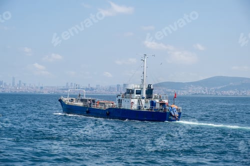 Preview: A blue cargo boat navigates through clear waters near Istanbul under a bright sky