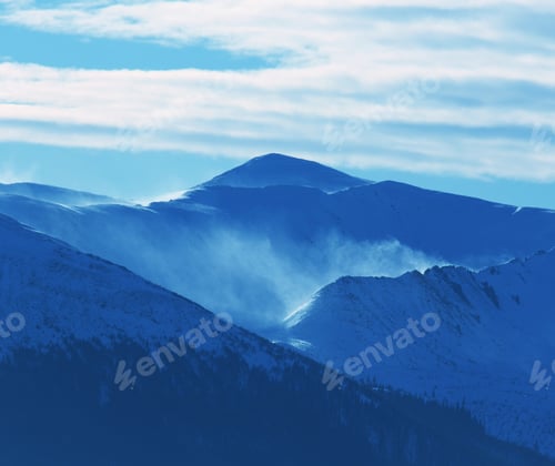 Snowy Mountain Range Under a Blue Sky