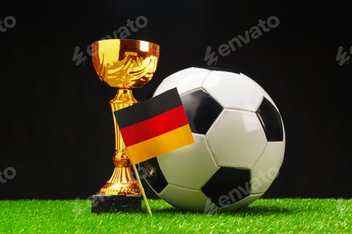 Preview: Soccer trophy with ball and German flag displayed on a green field background