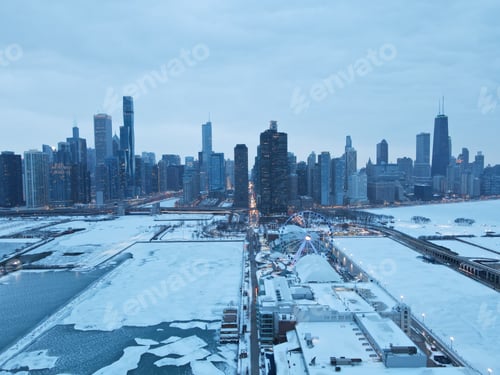 Preview: Stunning aerial view of a city skyline across a body of water during the winter season, Chicago