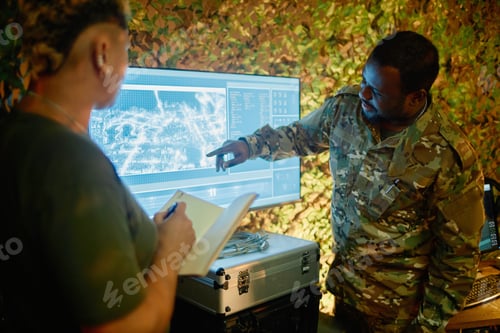 Preview: Young African American officer pointing at computer screen during report