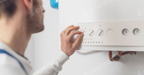 Preview: Professional plumber checking a boiler control panel