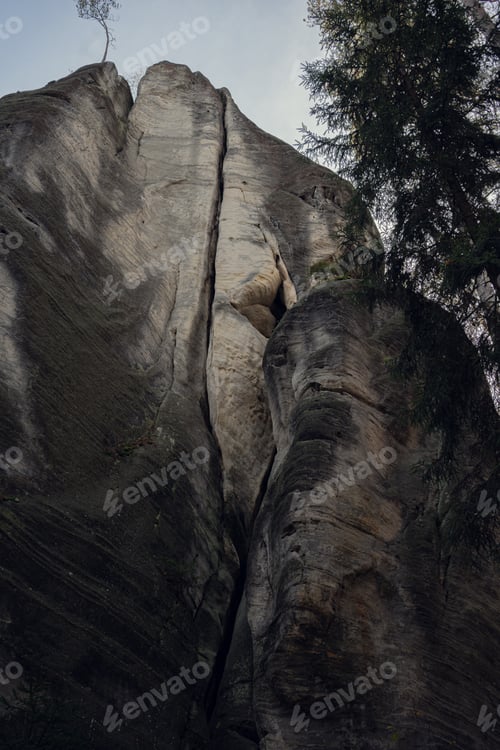Preview: Towering Rock Formation in Lush Green Forest - Natural Wonder