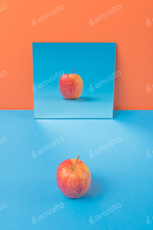 Preview: Apple on blue table isolated over orange background