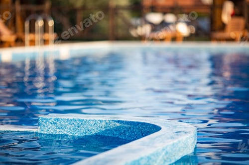 Preview: Top view of swimming pool with clear water on vacation on sunset background