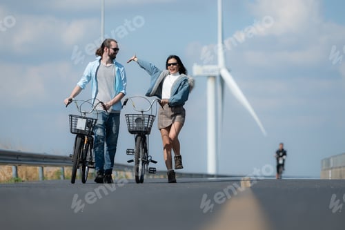 Preview: Young woman riding a bicycle with her boyfriend on the road