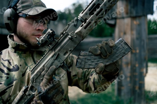 Preview: military tactical strategy NATO rifle position for reloading a weapon training at professional