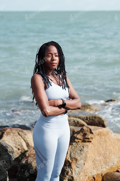 Preview: Young Sportswoman Standing on Rock