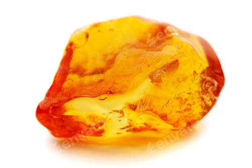 Preview: Natural amber. A piece of yellow opaque natural amber on white background
