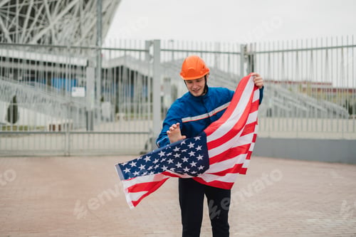 Preview: a patriontic american male worker holding usa national flag outdoors