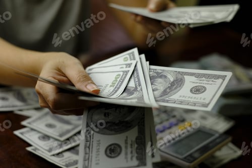 Preview: Businessmen women counting money on a stack of 100 US dollars banknotes