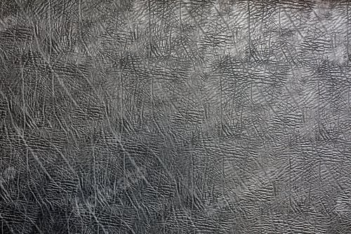 Preview: Black leather texture. A snapshot of a piece of black leather with a marbled texture in pieces and