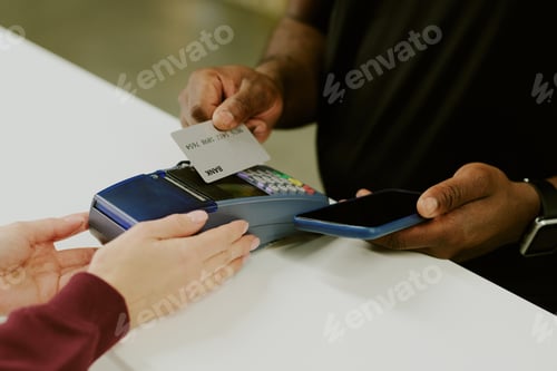 Preview: Man Making Payment at Reception Desk