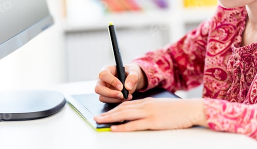 Preview: Little girl writing on graphics tablet