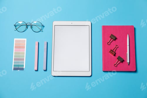 Preview: Tablet, different stationery and glasses on light blue background, flat lay
