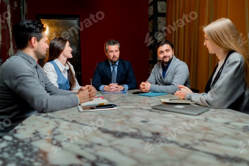 Preview: office workers are sitting at the head of the director discussing a business plan
