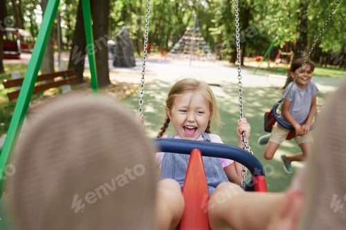 Preview: Cute little girl have fun at the swing set