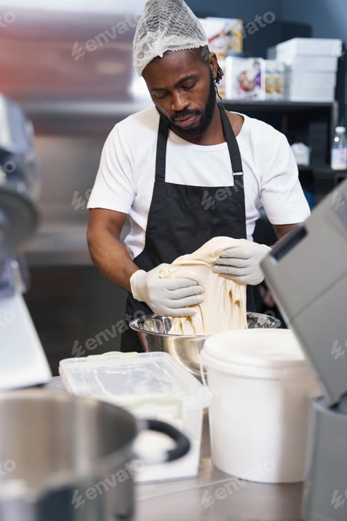 Preview: Man in protective clothes working at the kitchen