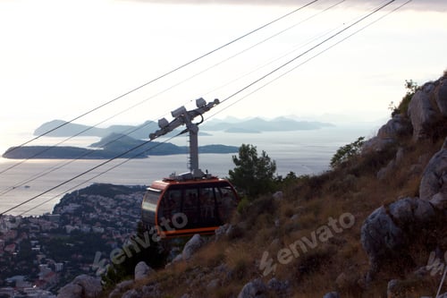 Preview: Aerial tram going up mountain over ocean in Dubrovnik
