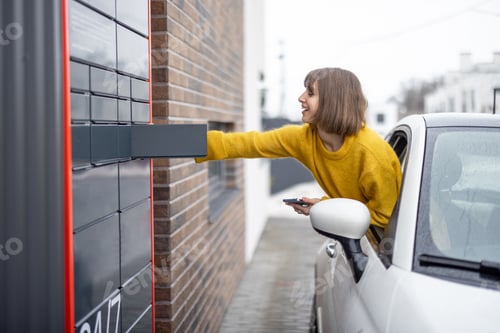 Preview: Woman getting parcel from the post office terminal right out of the car window on the go