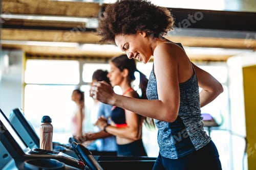 Preview: Group of happy fit people at the gym exercising, running. Stay healthy concept.