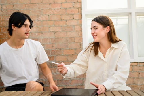 Preview: Couple of happy young people spending time together at home on weekend