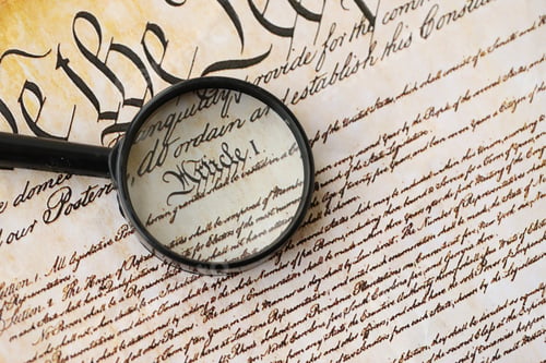 Preview: American USA Constitution paper page and magnifying glass close up