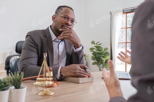 Preview: Lawyer having a discussion with a new client. Young male attorney at office desk, sharing legal