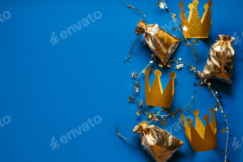 Preview: Happy Epiphany Day, Three Kings Day greeting card with three gold crowns on blue background