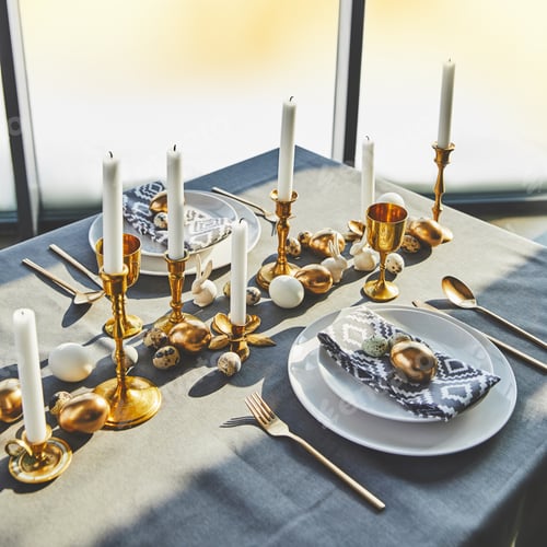 Preview: high angle view of easter eggs and candles on festive table with sunlight