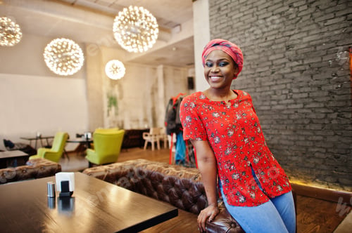 Preview: Stylish african woman in red shirt and hat