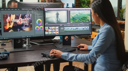 Preview: Asian film maker working on movie footage quality with editing software