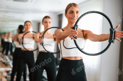 Preview: Exercises by using the circle device in hands. Women in fitness center