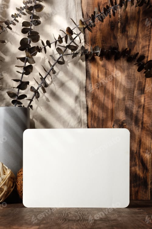 Preview: blank paper poster frame with kitchenware on wood table with sunlight