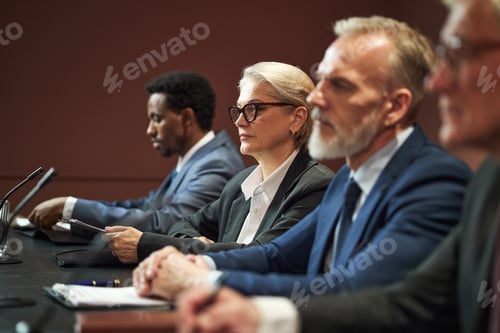 Preview: Middle Aged Multiethnic Politicians Attending Conference Meeting at Table