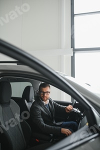 Preview: Young man in the car dealership.
