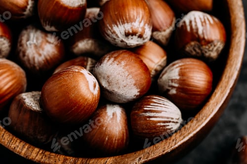 Preview: Hazelnuts. Whole Hazelnuts in wooden bowl on dark background