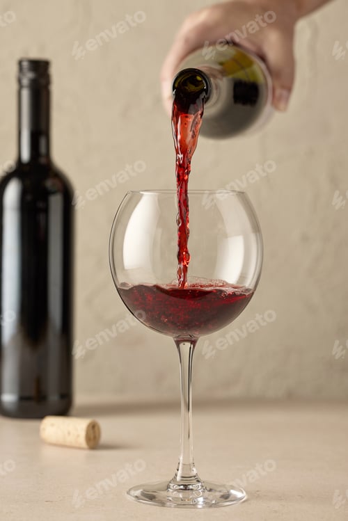 Preview: closeup of red wine pouring in glass
