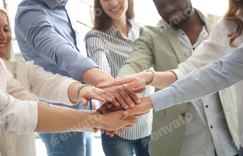 Preview: People putting hands together indoors. Unity concept