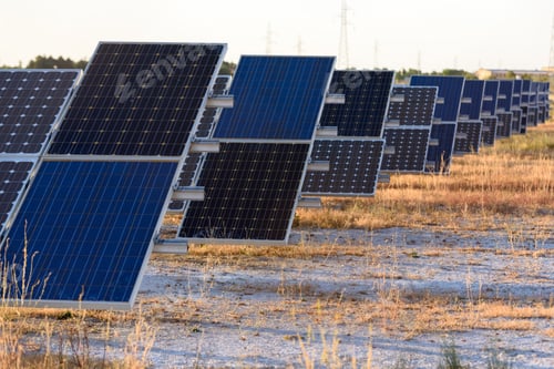 Preview: A semi-desert field with solar panels to generate electricity at sunset.